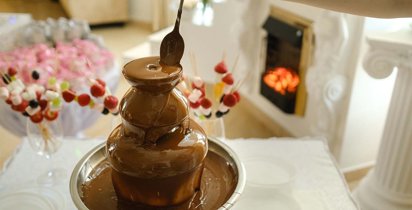 Chocolate fountain displayed in a decorated event setting