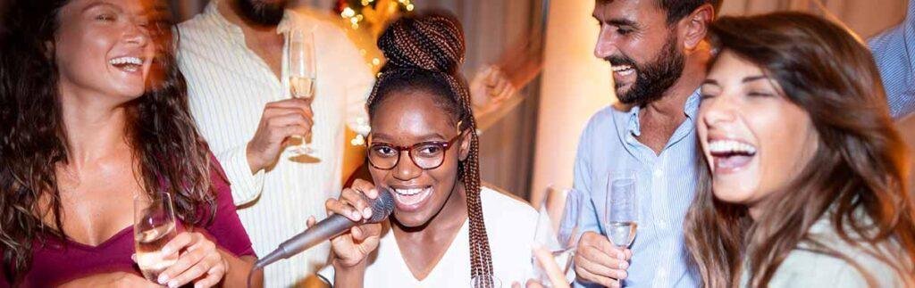  Friends singing karaoke together at a lively party