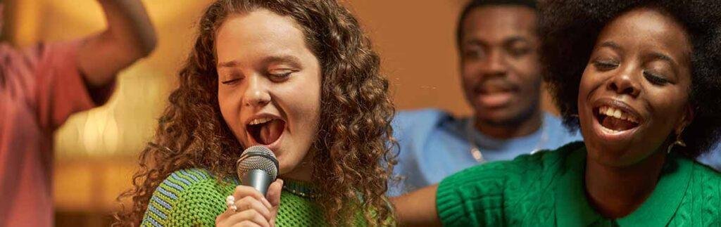 The History of Karaoke Modern karaoke night with friends singing and enjoying music together