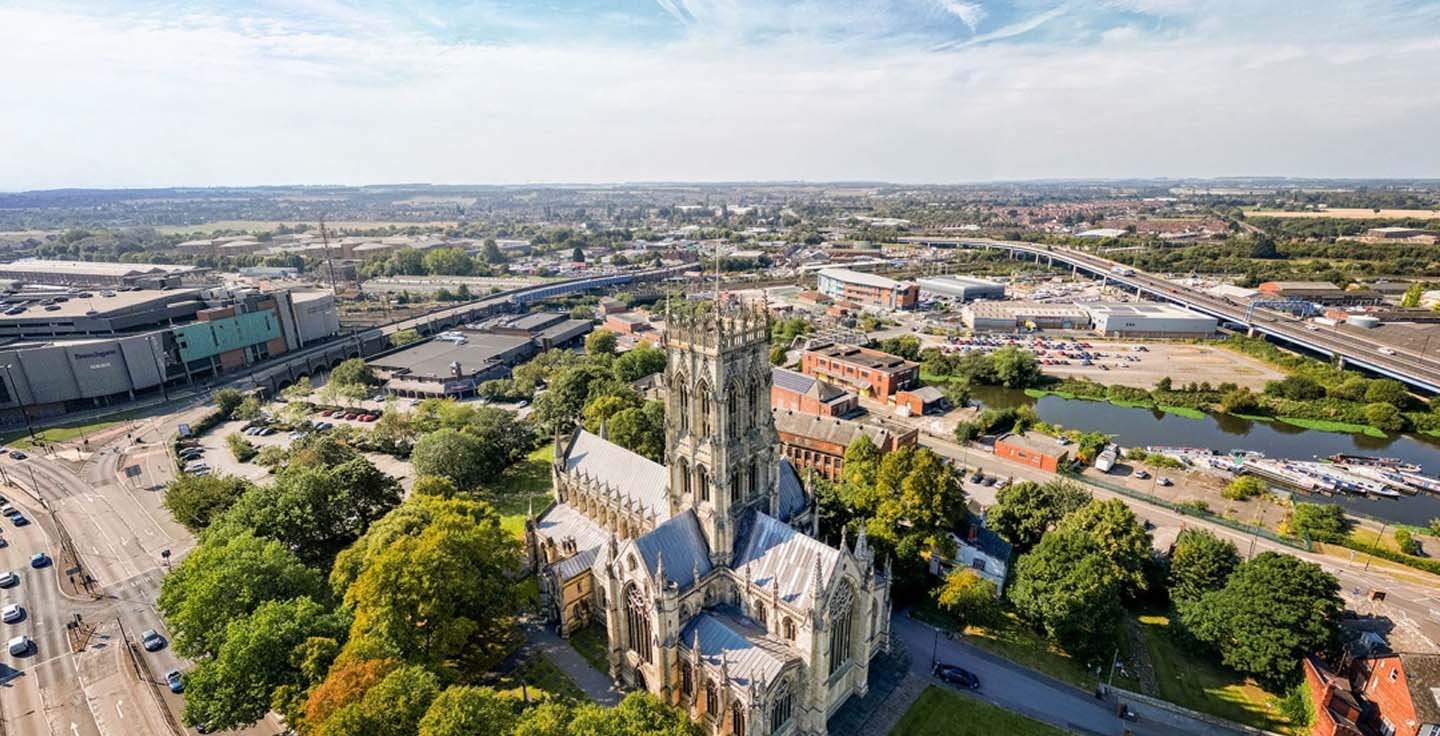 Aerial view of Doncaster featuring the Minster and surrounding cityscape