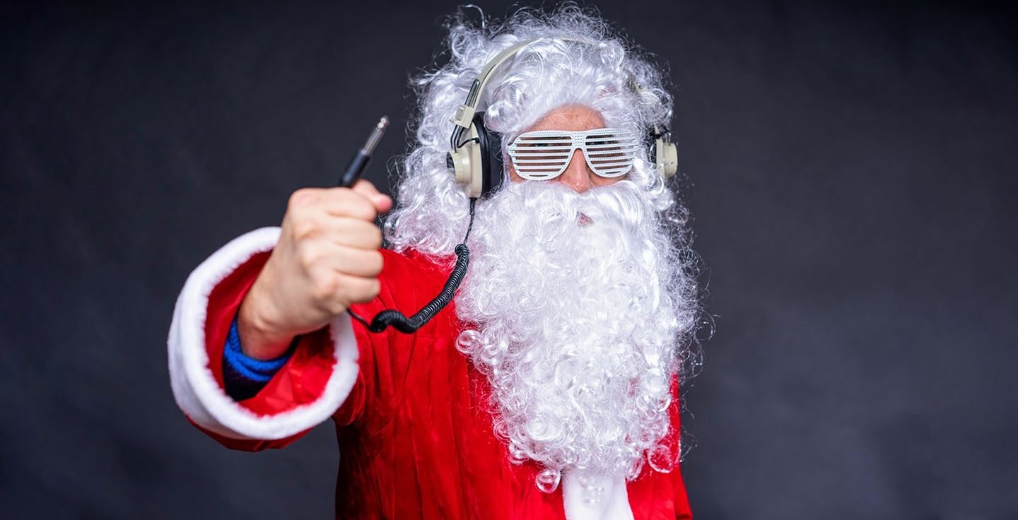 Santa Claus wearing headphones and posing like a DJ