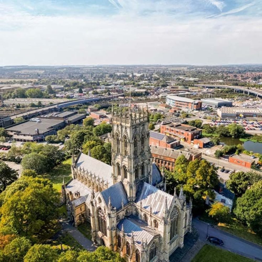 Aerial view of Doncaster featuring the Minster and surrounding cityscape