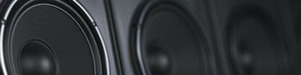 Stack of black event speakers at a venue