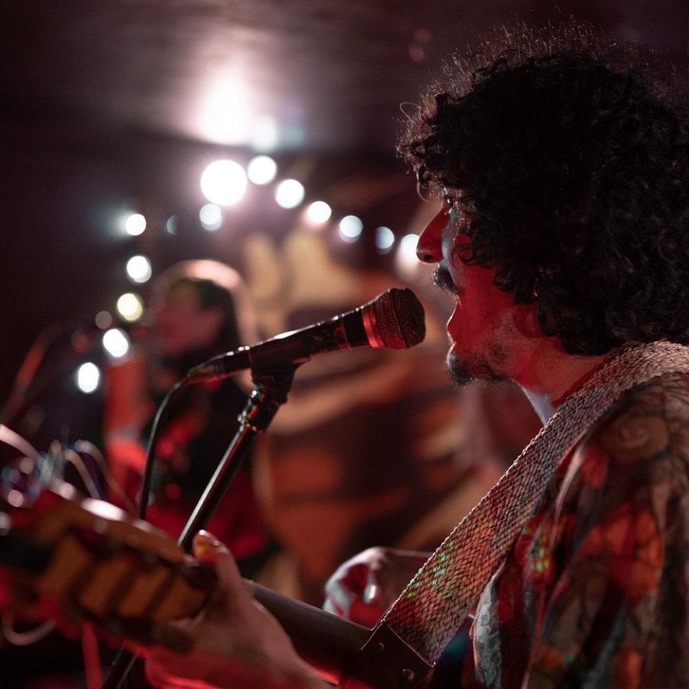 we launch Guitarist singing into a microphone during a live show