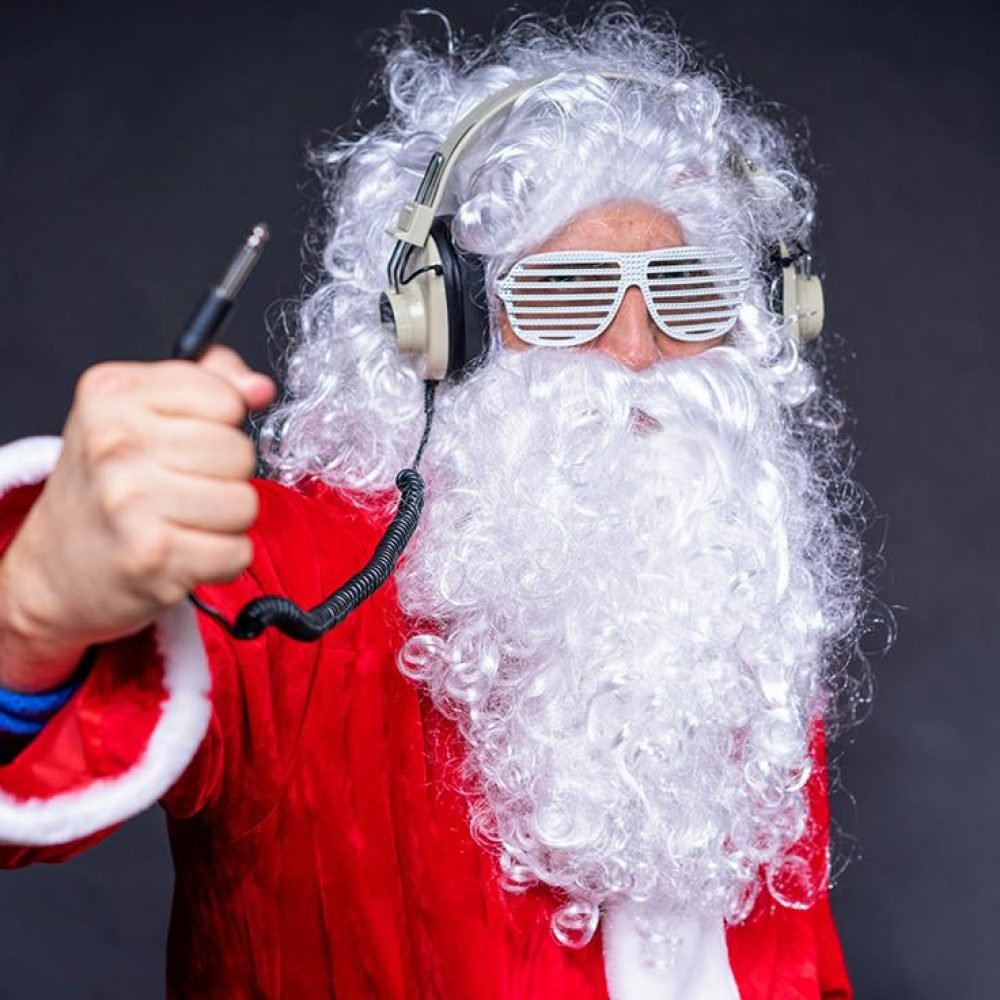 Santa Claus wearing headphones and posing like a DJ